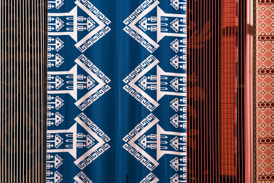 A display of traditional Indonesian fabric named batik with colorful patterns.