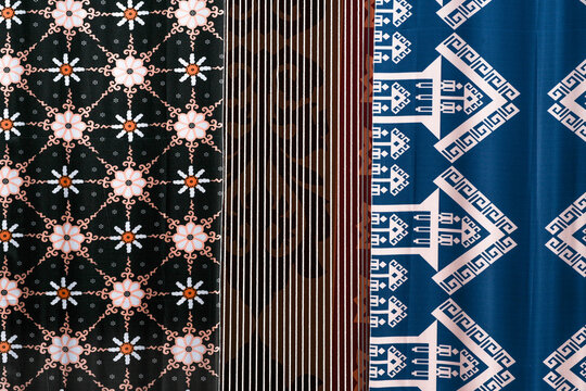 A display of traditional Indonesian fabric named batik with colorful patterns.