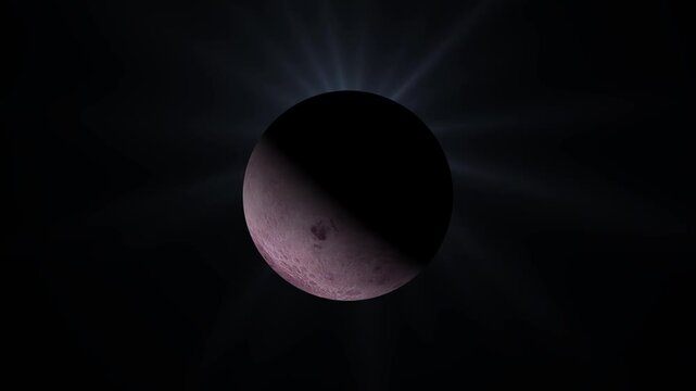 Partial lunar eclipse with glowing light rays visible in the dark