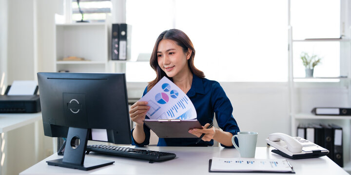 Laptop, documents and asian woman with audit for finance review, person with papers, graphs or report for financial planning.