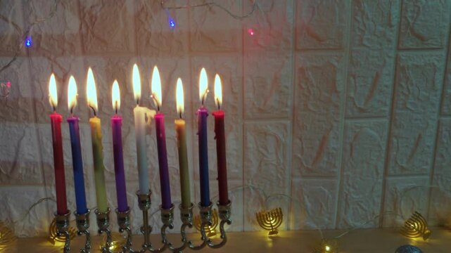 Hanukkah menorah with nine lit colorful candles