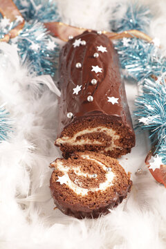 festive chocolate yule log cake slice with christmas decorations top view