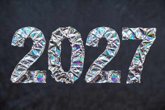 New year 2027 is shown with shiny foil numbers against a dark background