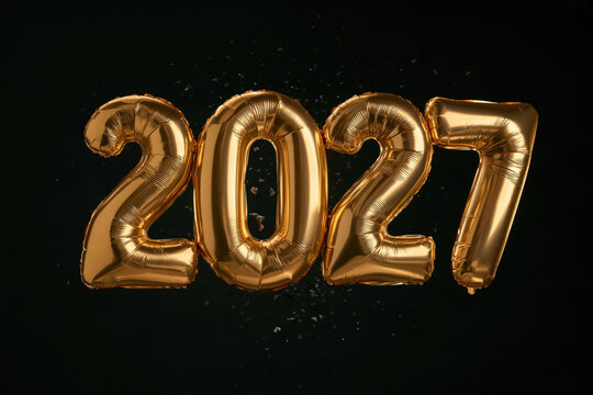 Gold balloons shaped as the number 2027 against a dark background