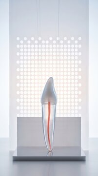 Glass incisor tooth with red root canal against dot panel, patient care