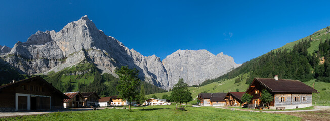 Fototapeta premium The morning panorama of north walls of Karwendel mountains - walls of Spritzkarspitze and Grubenkarspitze from Enger tall in the Grosser Ahornboden walley.