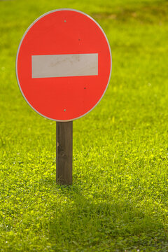 No entry traffic sign standing in green grass
