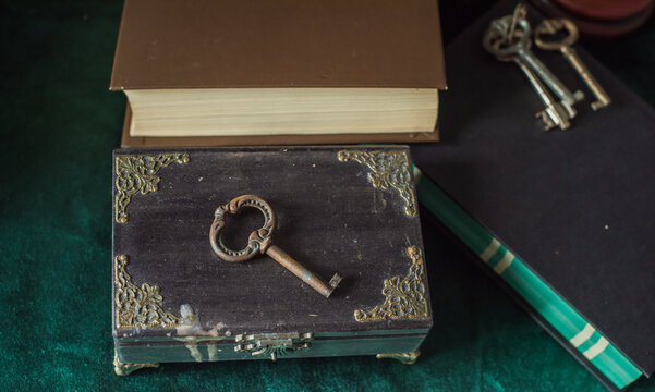 Vintage key arranged in an atmospheric antique setting, symbolizing the discovery of secrets, hidden knowledge and answers to unanswered questions. Mysterious conceptual still life evoking spiritual 