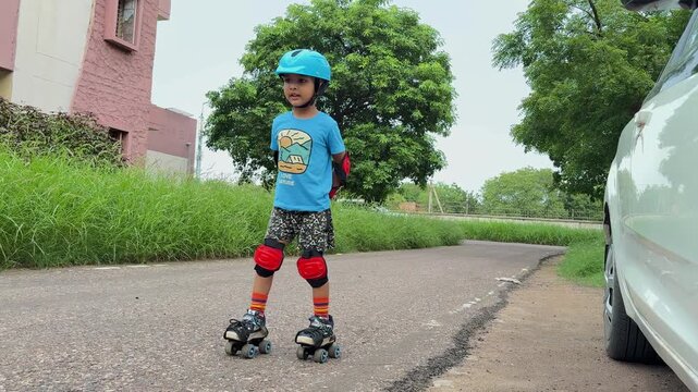 Child Learning Roller Skating Wearing Helmet Knee Pads and Protective Gear