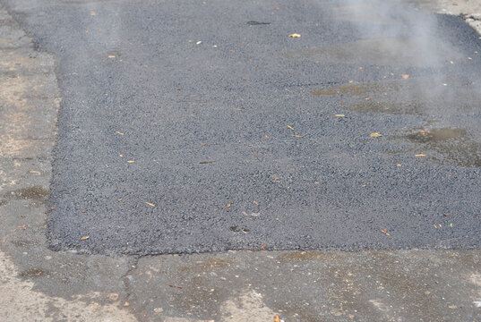 Asphalt road patching pothole repair