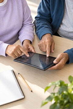 Older adults share a tablet during a collaborative learning session