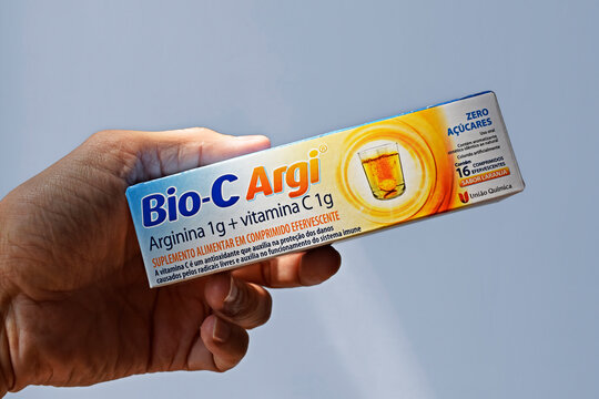 RIO DE JANEIRO, BRAZIL - September 26, 2026: Hand holding a box of effervescent vitamin C tablets 