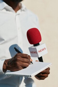 News reporter holding notebook and pen with red microphone for vertical interview background and press banner design for journalism and field reporting