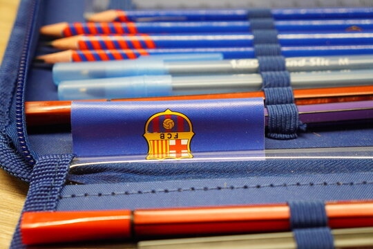 FC Barcelona branded pencil case filled with colorful writing instruments and school supplies