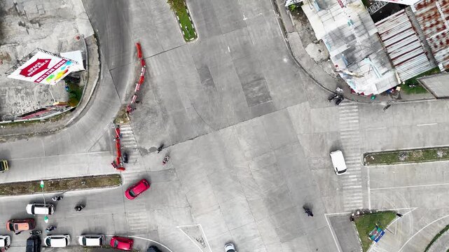 Aerial view of the Soreang intersection in Bandung with cars and motorcycles navigating the junction in Bandung, West Java, Indonesia.