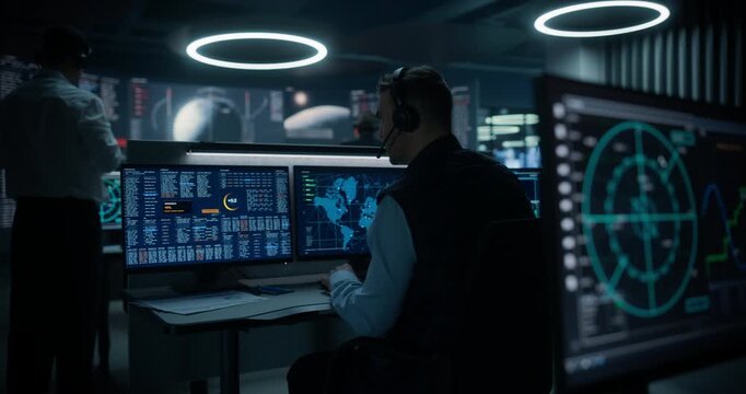 Monitoring Control Room. Operators Track a Spacecraft Signal Through Circular Radar, Frequency Waveforms, Code Logs and a World Map, Assessing Communications and Earth-orbit Coverage in Real Time.