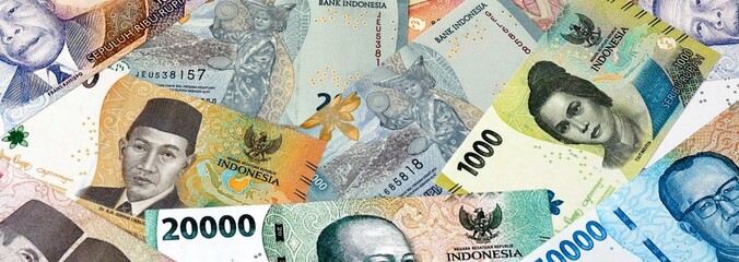 Big amount of Indonesian rupiah money banknotes. Indonesia cash bills of IDR currency close up © Marharyta
