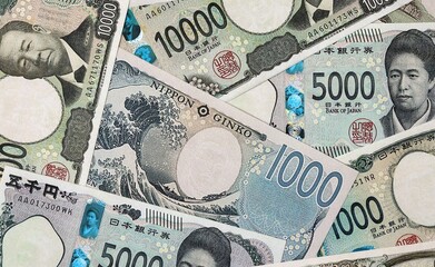 Big amount of Japanese yen money banknotes. Japan cash bills of JPY currency close up © Marharyta