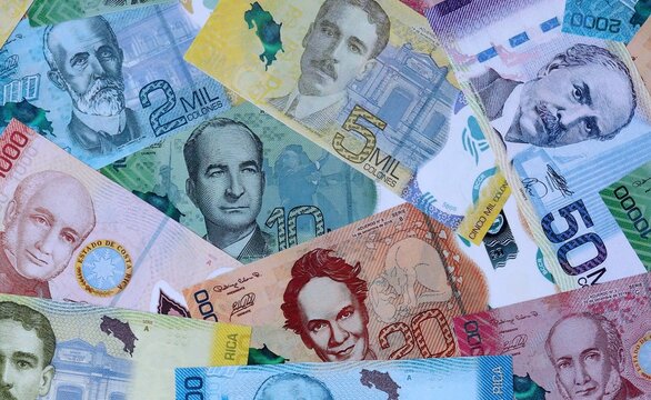 Big amount of Costa Rican colon money banknotes. Costa Rica cash bills of CRC currency close up