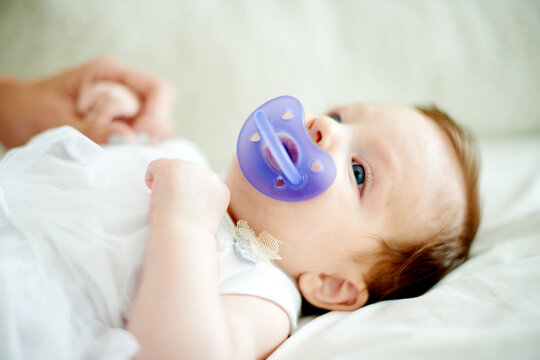 Relax, calm or infant with pacifier on bed for self soothing, provide comfort or sleeping help. Rest, emotion regulation or baby girl with dummy in home for nap time, child reflex or distraction