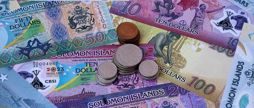 Solomon Islands dollar money notes and coins on table. Solomon Islands cash bills of SBD currency