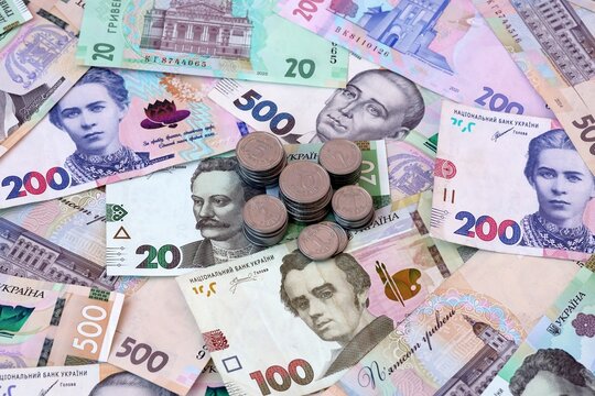 Ukrainian hryvnia money notes and coins on table. Ukraine cash bills of UAH currency close up