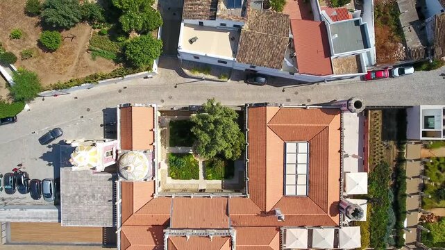 Revealing aerial top down view of estoi palace in the algarve, showcasing rococo architecture, ornate gardens, inner courtyard and adjacent luxury pousada hotel facilities