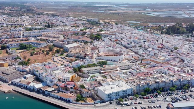 Breathtaking aerial view of ayamontes whitewashed houses, historic bullring and peaceful guadiana river estuary along the andalusian coast, perfect coastal travel scene