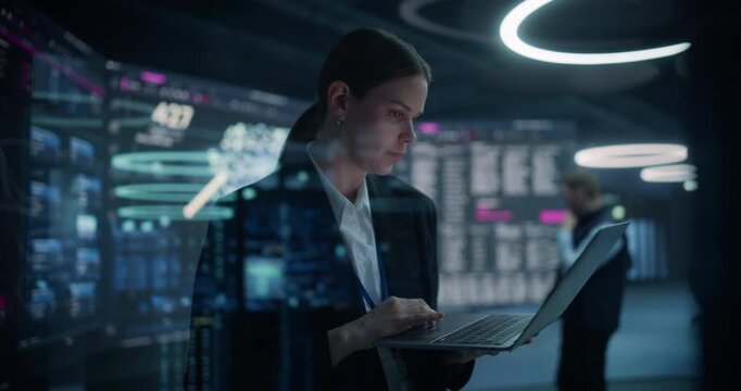 Portrait of a Female Analyst Using a Laptop to Optimise Banking Transactions and Ecommerce Growth While a Cybersecurity Specialist Monitors Neural Network Dashboards in a Data Analytics Firm.
