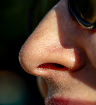 Close-up of human nose with sunglasses