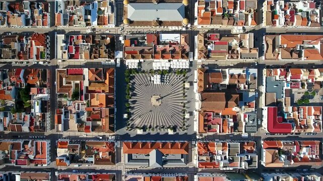 Drone flying over the historic center of vila real de santo antonio in the algarve region, showcasing the grid like urban planning and the marques de pombal square with its distinctive paving