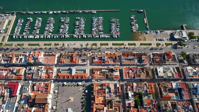 Spectacular aerial perspective flying over the picturesque town of vila real de santo antonio, showcasing its historic city center, praca marques de pombal, and the bustling marina