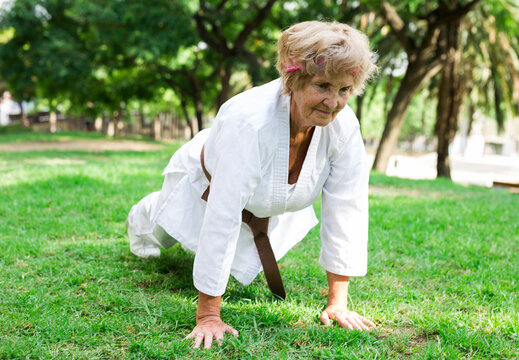 Old woman in kimono training in park
