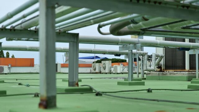 Outdoor commercial HVAC equipment with large heat exchanger panels and connected pipes for efficient building climate control.