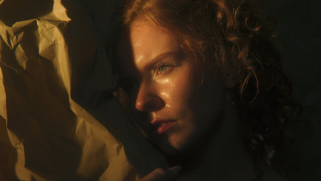 Woman Surrounded by Darkness Turns Toward Warm Light, Suggesting Inner Strength, Clarity, Emotional Renewal. Poetic Portrait Represents Hope, Resilience, Finding New Perspective. Sense of Worthiness.