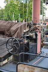 Vintage Sailboat Deck With Mast, Winch, Ropes and Covered Boom in Harbor Rigging © Chris Willemsen