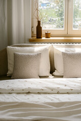 Fototapeta premium Bedroom interior with pillows and white bedding on bed