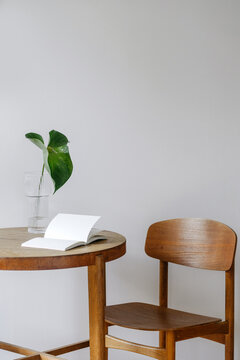 Cozy kitchen with dining table, wooden chair, and green plant on morning light