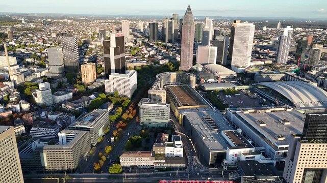 Aerial view of the modern skyline of Frankfurt am Main featuring skyscrapers, the Messe Frankfurt exhibition center, and urban infrastructure in Frankfurt am Main, Hessen, Germany.
