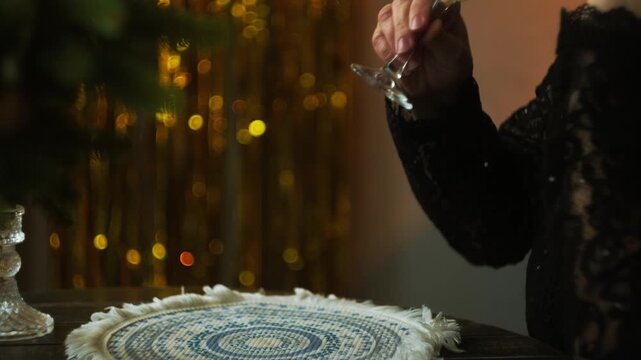 Woman drinking champagne during festive event. Celebrating New Year Eve alone or waiting for partner on date