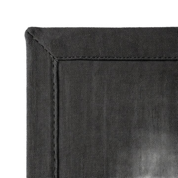 Charcoal linen drape macro crop showing mitred hem and sewn-in weight pocket on transparent background