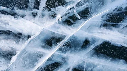 Abstract texture of blue ice cracks and natural patterns on frozen Lake Baikal. Abstract winter background and surface detail. © Viks_jin