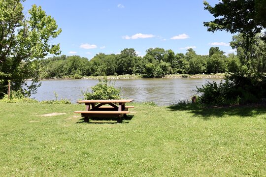 The empty wood picnic table in the park.