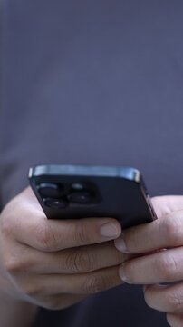 man holds smart phone in her hands and scrolls through the news feed. Close up of hand uses mobile. point finger on screen, texting text message.