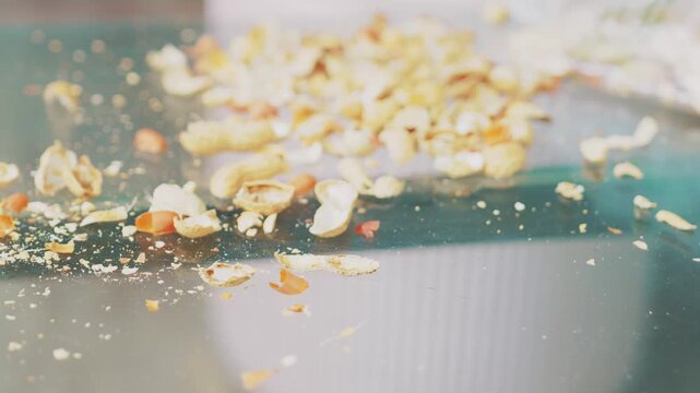 Scattered Empty Peanut Shells and Hulls on Clear Glass Table
