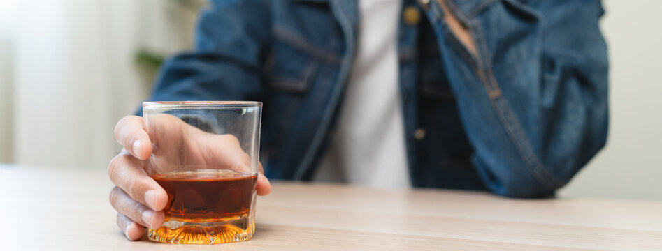 depression and anxiety woman drinking whisky alone.