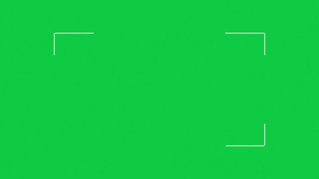 Camera viewfinder focus box with thin white corner brackets drawing in one by one on a chroma key green screen, holding steady at the center before the whole frame fades out all at once