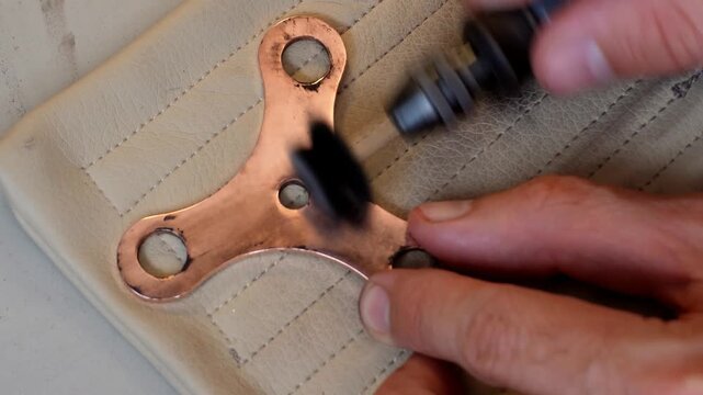 Rotary tool buffing and chemical cleaning procedures applied to a perforated metal component during advanced workshop surface finishing stages