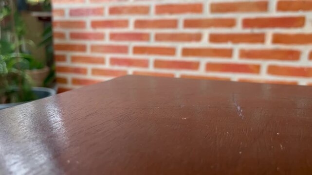 Wooden table and brick wall