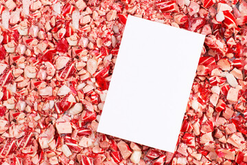 Blank paper card mockup on crushed candy cane background for Christmas and holiday greetings © Kati_Konn